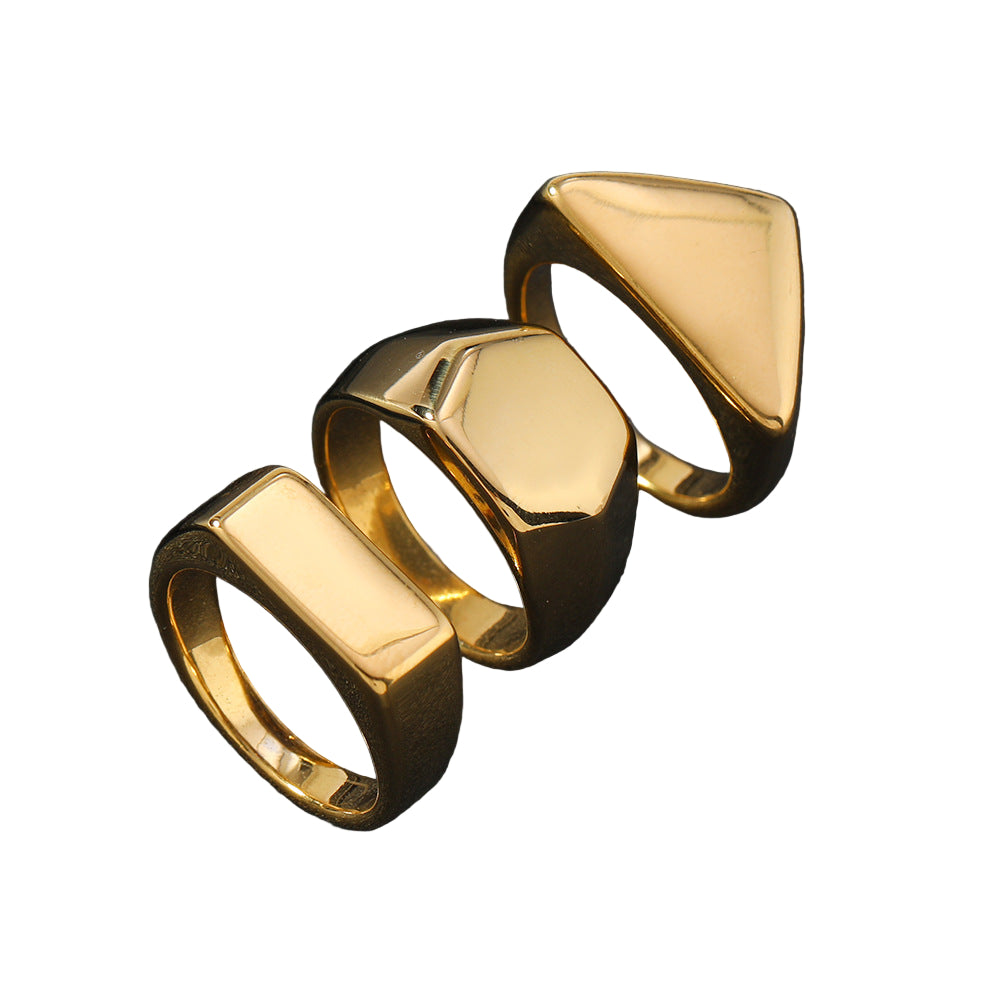 Three gold rings with geometric designs on a white background